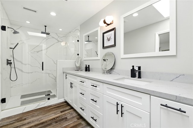 3101 Maple Ave, Fullerton, CA 92835 - full bath featuring recessed lighting, double vanity, a marble finish shower, and wood finished floors