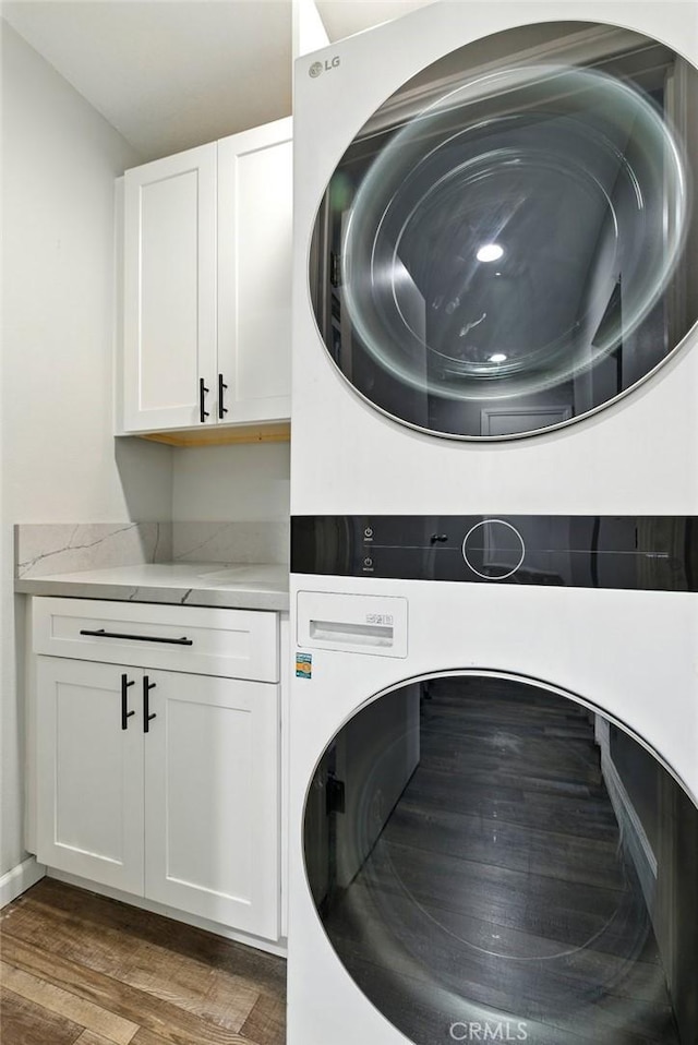 3101 Maple Ave, Fullerton, CA 92835 - laundry room with estacked washer and dryer, cabinet space, and wood finished floors
