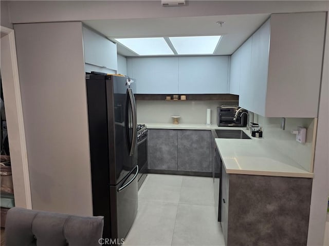 612 N Columbus Ave Unit 101, Glendale, CA 91203 - kitchen with freestanding refrigerator, gas stove, and light countertops