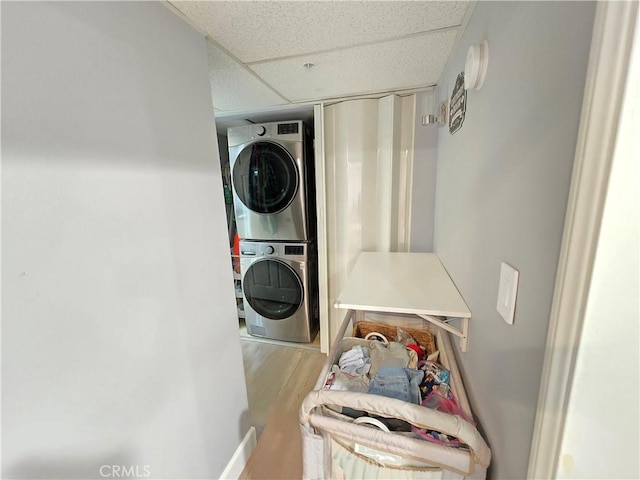 612 N Columbus Ave Unit 101, Glendale, CA 91203 - washroom featuring estacked washer and dryer and wood finished floors