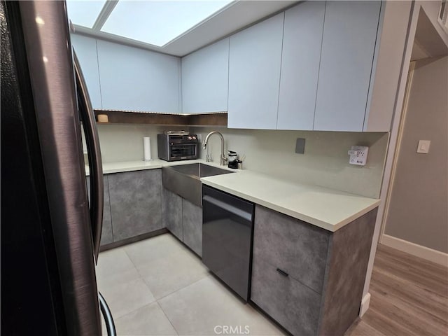 612 N Columbus Ave Unit 101, Glendale, CA 91203 - kitchen featuring freestanding refrigerator, dishwashing machine, light countertops, and modern cabinets