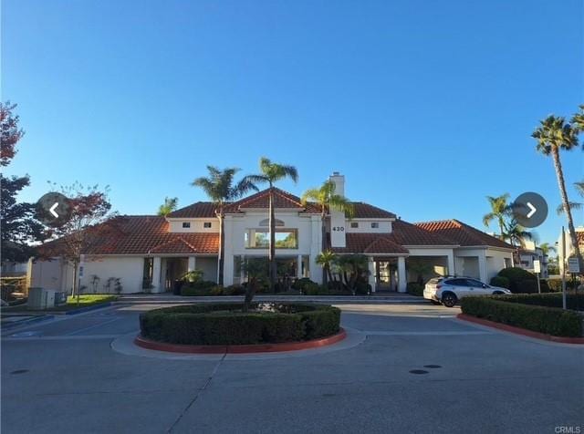 300 Isthmus Way Unit 6, Oceanside, CA 92058 - view of front facade featuring a tile roof and a chimney