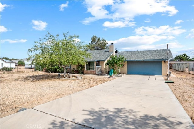 14551 Jelan Ave, Apple Valley, CA 92307 - view of front of house featuring an attached garage, driveway, and a chimney