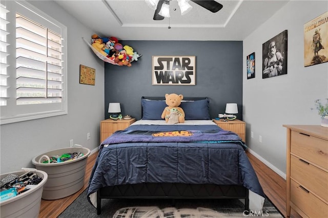 7733 Pismo Ave, Hesperia, CA 92345 - bedroom featuring wood finished floors, a raised ceiling, and ceiling fan