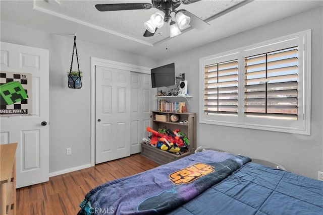 7733 Pismo Ave, Hesperia, CA 92345 - bedroom with wood finished floors, a closet, and ceiling fan