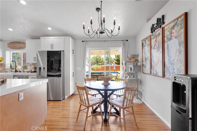 7733 Pismo Ave, Hesperia, CA 92345 - dining room with a chandelier, light wood-style floors, plenty of natural light, a textured ceiling, and recessed lighting