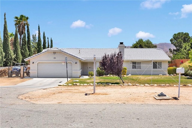 7733 Pismo Ave, Hesperia, CA 92345 - ranch-style home featuring a tile roof, a chimney, an attached garage, driveway, and stucco siding