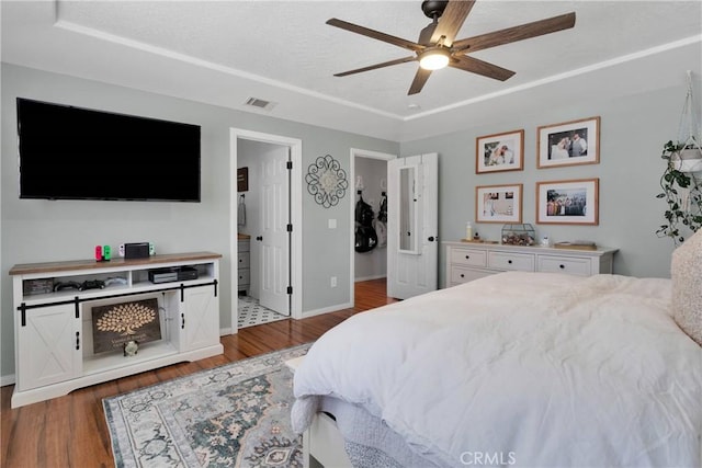 7733 Pismo Ave, Hesperia, CA 92345 - bedroom with wood finished floors, ceiling fan, and connected bathroom