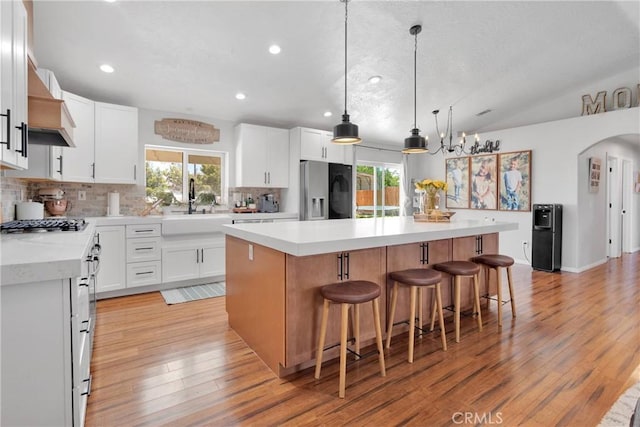 7733 Pismo Ave, Hesperia, CA 92345 - kitchen featuring fridge with ice dispenser, backsplash, plenty of natural light, light wood-style floors, and recessed lighting