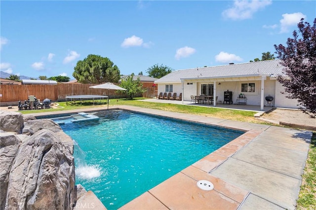 7733 Pismo Ave, Hesperia, CA 92345 - view of pool featuring a patio, a trampoline, a fenced backyard, a pool with connected hot tub, and outdoor dining space