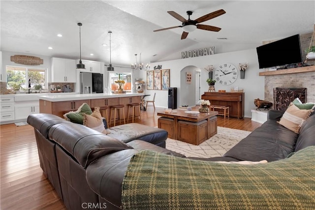 7733 Pismo Ave, Hesperia, CA 92345 - living area with ceiling fan, light wood-style flooring, a fireplace, recessed lighting, and lofted ceiling