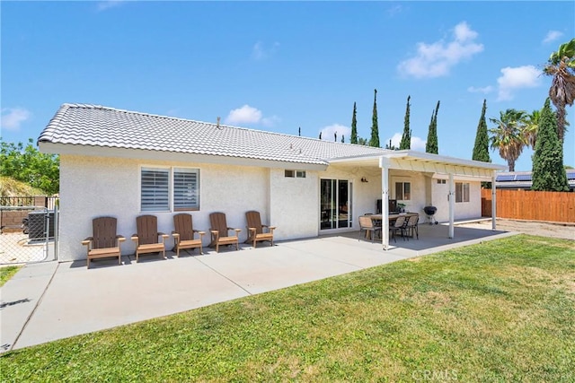 7733 Pismo Ave, Hesperia, CA 92345 - rear view of house with a tile roof, stucco siding, and a patio area
