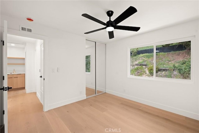 4282 Robbins St, San Diego, CA 92122 - unfurnished bedroom featuring light wood-style floors, a closet, and ceiling fan