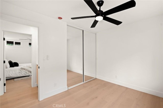4282 Robbins St, San Diego, CA 92122 - unfurnished bedroom with light wood-style flooring, a closet, and a ceiling fan