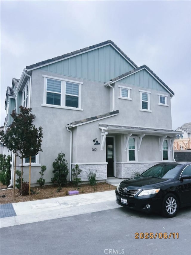 762 Jasper St, Mission Viejo, CA 92694 - view of front of house with stucco siding, stone siding, board and batten siding, and a tile roof