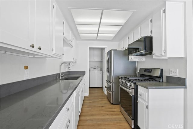 6443 Olive Branch Ln Unit 11, Yorba Linda, CA 92886 - kitchen with gas range, washer / clothes dryer, light wood finished floors, and white cabinetry