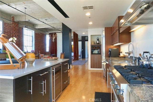 207 Broadway E Unit 302, Long Beach, CA 90802 - kitchen featuring wine cooler, island exhaust hood, light wood-type flooring, light countertops, and modern cabinets