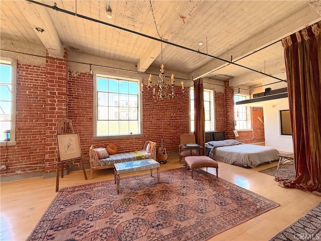 207 Broadway E Unit 302, Long Beach, CA 90802 - bedroom featuring multiple windows, brick wall, wood finished floors, a wooden ceiling with exposed beams, and a chandelier
