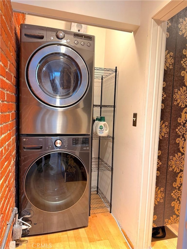 207 Broadway E Unit 302, Long Beach, CA 90802 - washroom with stacked washer / dryer, wood finished floors, and brick wall