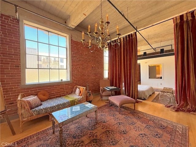 207 Broadway E Unit 302, Long Beach, CA 90802 - sitting room featuring brick wall, wood-type flooring, a chandelier, and a wood ceiling with exposed beams