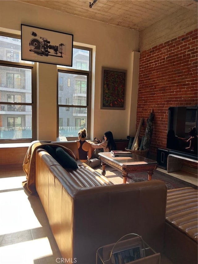 207 Broadway E Unit 302, Long Beach, CA 90802 - living room featuring wooden ceiling and brick wall