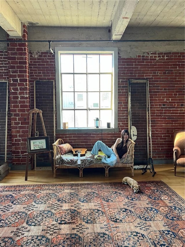 207 Broadway E Unit 302, Long Beach, CA 90802 - living room featuring wood finished floors, brick wall, and beam ceiling