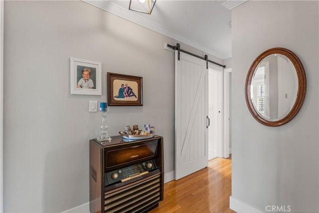 1050 Marvista Ave, Seal Beach, CA 90740 - hall featuring light wood-style floors, a barn door, and ornamental molding