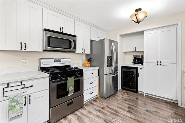 5655 Clearwater Dr, Yorba Linda, CA 92887 - kitchen featuring stainless steel appliances, beverage cooler, white cabinetry, light wood-style flooring, and light stone counters