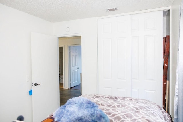 575 Prairie Way, Perris, CA 92571 - bedroom with a closet, dark wood-type flooring, and a textured ceiling