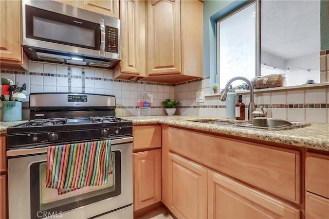 2501 W Redondo Beach Blvd Unit 306, Gardena, CA 90249 - kitchen featuring stainless steel appliances, decorative backsplash, light brown cabinets, and light stone countertops