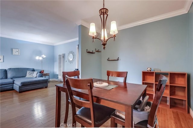 2501 W Redondo Beach Blvd Unit 306, Gardena, CA 90249 - dining room featuring ornamental molding, light wood-style floors, and a chandelier