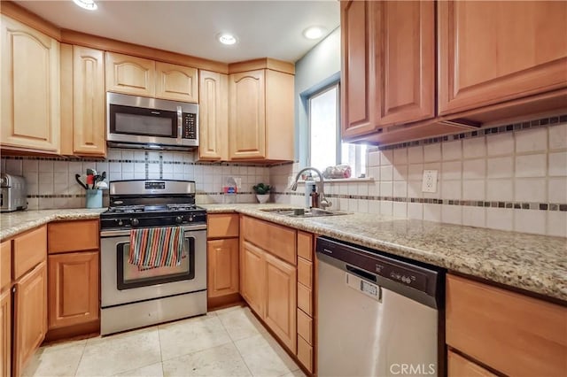 2501 W Redondo Beach Blvd Unit 306, Gardena, CA 90249 - kitchen with appliances with stainless steel finishes, tasteful backsplash, light tile patterned floors, light stone countertops, and recessed lighting