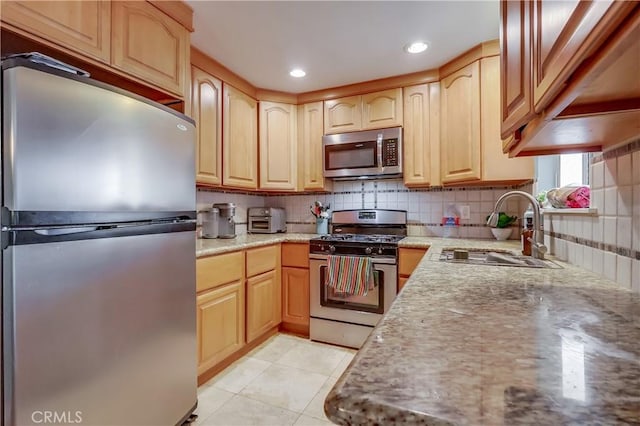 2501 W Redondo Beach Blvd Unit 306, Gardena, CA 90249 - kitchen featuring stainless steel appliances, tasteful backsplash, light brown cabinetry, light stone counters, and recessed lighting