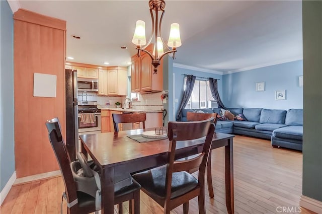 2501 W Redondo Beach Blvd Unit 306, Gardena, CA 90249 - dining room with light wood finished floors, a chandelier, and ornamental molding