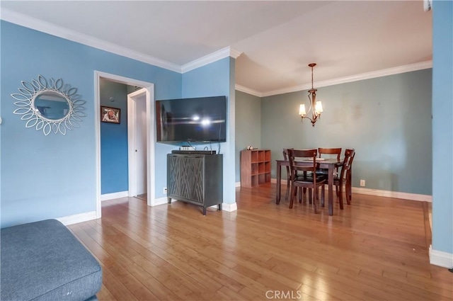 2501 W Redondo Beach Blvd Unit 306, Gardena, CA 90249 - dining space featuring hardwood / wood-style flooring, a chandelier, and crown molding