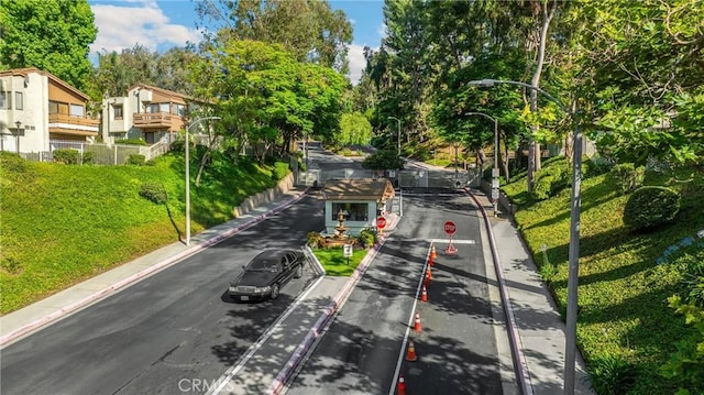 22709 Lakeway Dr Unit 493, Diamond Bar, CA 91765 - view of asphalt street featuring traffic signs, street lighting, curbs, and view of scattered trees