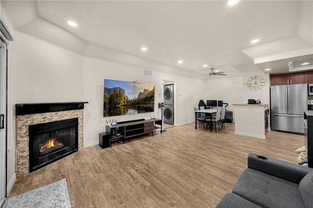 22709 Lakeway Dr Unit 493, Diamond Bar, CA 91765 - living area with estacked washer and dryer, light wood-type flooring, a stone fireplace, recessed lighting, and ceiling fan