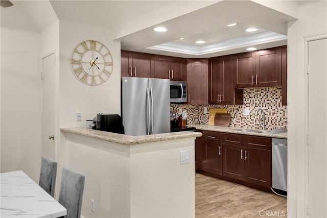 22709 Lakeway Dr Unit 493, Diamond Bar, CA 91765 - kitchen featuring stainless steel appliances, recessed lighting, backsplash, light wood-type flooring, and a tray ceiling