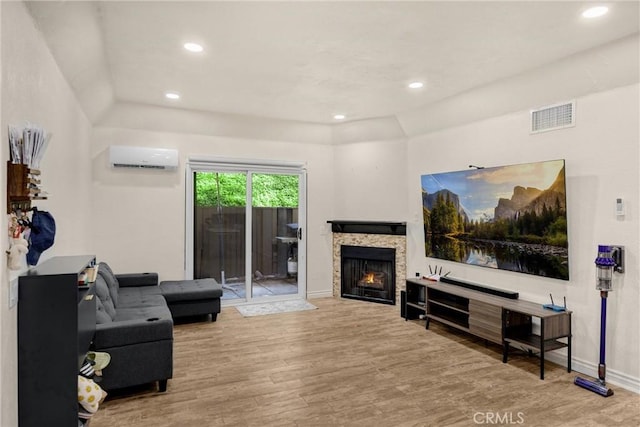 22709 Lakeway Dr Unit 493, Diamond Bar, CA 91765 - living area featuring a wall mounted air conditioner, wood finished floors, a warm lit fireplace, and recessed lighting