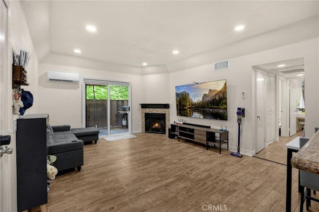 22709 Lakeway Dr Unit 493, Diamond Bar, CA 91765 - living room with a wall unit AC, wood finished floors, a warm lit fireplace, and recessed lighting