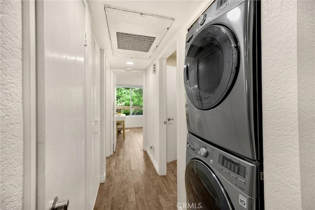 22709 Lakeway Dr Unit 493, Diamond Bar, CA 91765 - washroom with stacked washing machine and dryer, wood finished floors, and a textured wall