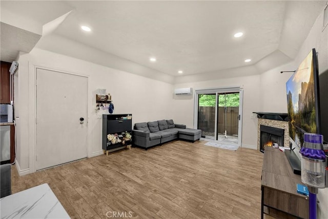 22709 Lakeway Dr Unit 493, Diamond Bar, CA 91765 - living area featuring a wall mounted AC, light wood-style flooring, a stone fireplace, and recessed lighting
