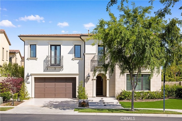 127 Interstellar, Irvine, CA 92618 - mediterranean / spanish-style home with a balcony, driveway, a garage, a tiled roof, and stucco siding