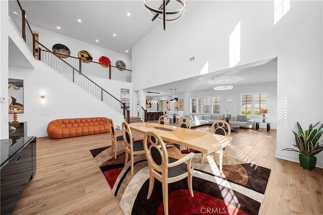 127 Interstellar, Irvine, CA 92618 - dining area featuring stairway, a high ceiling, wood finished floors, and recessed lighting