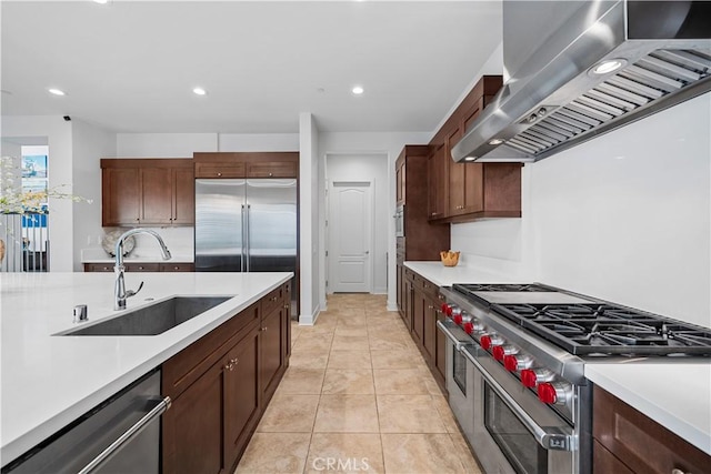 127 Interstellar, Irvine, CA 92618 - kitchen featuring wall chimney exhaust hood, high end appliances, light countertops, and recessed lighting