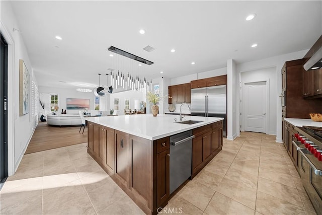 127 Interstellar, Irvine, CA 92618 - kitchen featuring premium appliances, open floor plan, recessed lighting, light countertops, and a large island with sink
