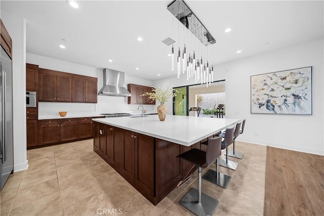 127 Interstellar, Irvine, CA 92618 - kitchen with wall chimney exhaust hood, light countertops, recessed lighting, a center island with sink, and hanging light fixtures