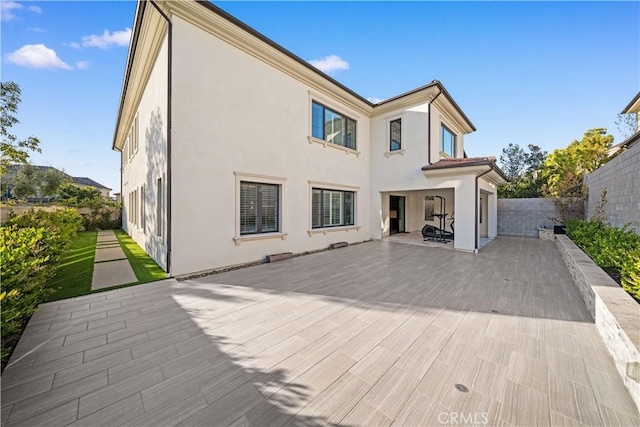 127 Interstellar, Irvine, CA 92618 - rear view of house featuring stucco siding and a patio