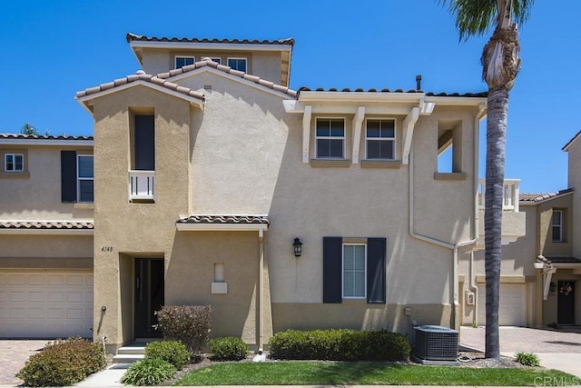 4148 Karst Rd, Carlsbad, CA 92010 - view of front facade with a tiled roof, stucco siding, and an attached garage