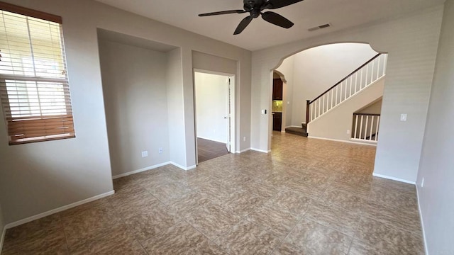 4148 Karst Rd, Carlsbad, CA 92010 - unfurnished room featuring arched walkways, ceiling fan, and stairway